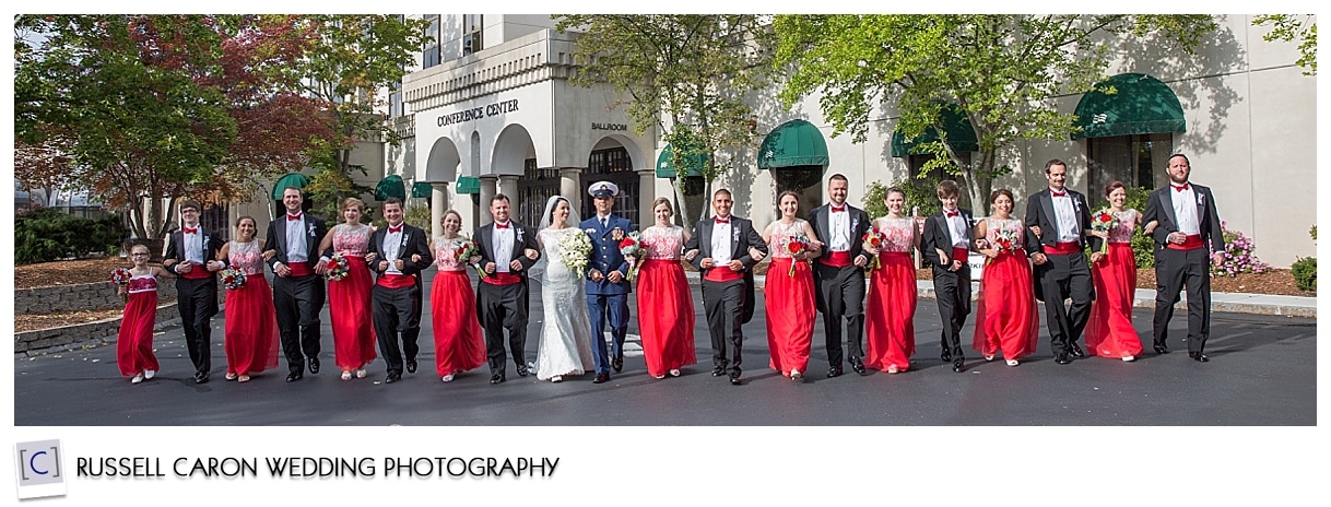 Bridal party walking with arms linked